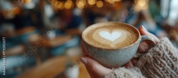 Fototapeta Warm winter latte with heart foam art enjoyed in a cozy cafe during the festive Christmas season