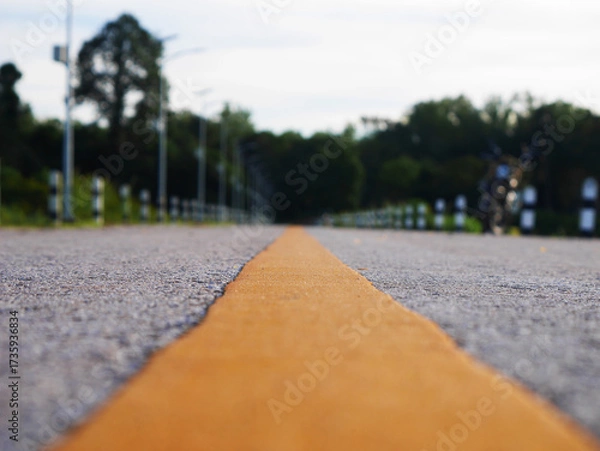 Fototapeta Asphalt road surface with yellow line, Surface grunge rough of asphalt, Dark grey with yellow line on the road and small rock, Texture Background, Top view