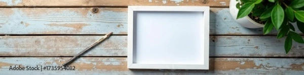Fototapeta Empty white picture frame on weathered wood tabletop , old, surface