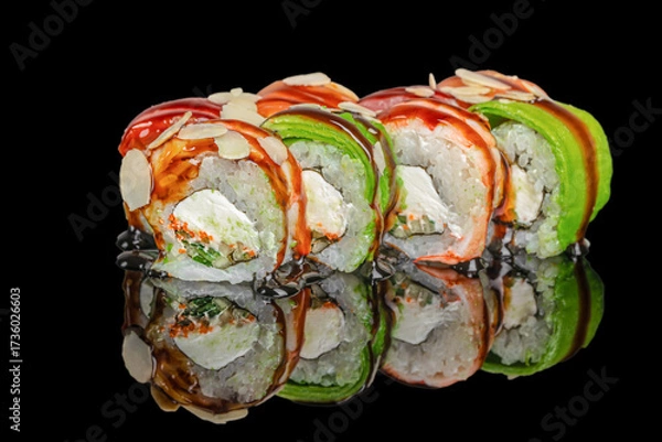 Fototapeta Fresh assorted sushi rolls with avocado, salmon, cream cheese, and almond slices served on a reflective black surface