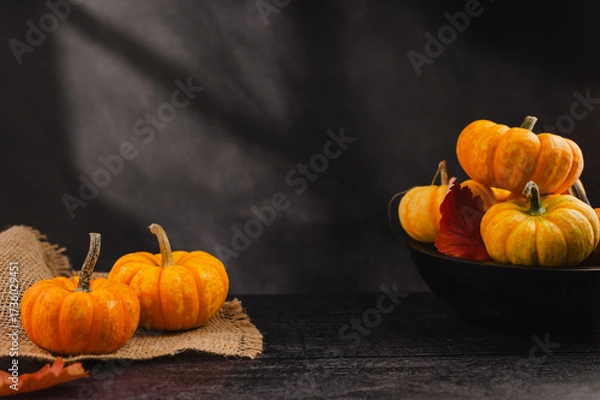 Fototapeta Orange pumpkins on dark background, abstract autumn, concept, copy space