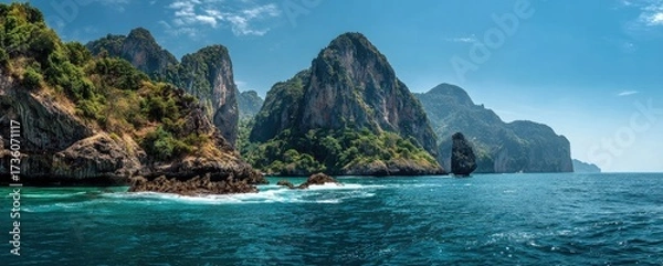 Fototapeta Turquoise water laps against dramatic limestone cliffs. Lush vegetation clings to the rocky shores