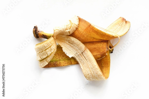 Fototapeta Rotten banana peel on white table. Photo can be used for the concept of the benefits of banana peel.