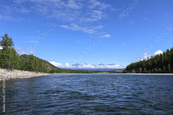Fototapeta Mountain ridge with clouds covering the middle, peaks and base visible