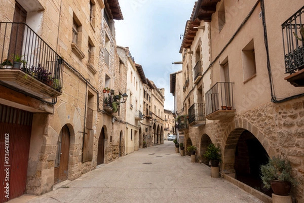 Fototapeta The historic Calle Mayor (main street), with 16th-18th century architecture, in the old town of La Fresneda, Spain.