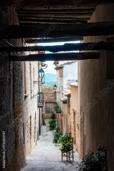 Fototapeta A narrow medieval alley (13th-18th century) in the historic old town of La Fresneda, Aragon, Spain.