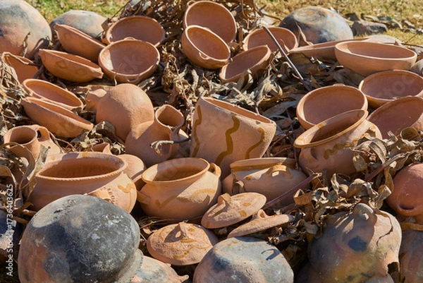 Fototapeta the firing process of clay pottery in Huancas brings earth to life. Each vessel, shaped by ancestral hands, hardens in the heat, transforming into a timeless symbol of tradition, 