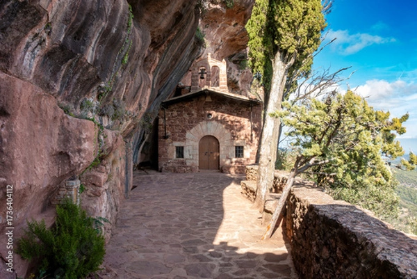 Fototapeta The 16th-century rock-hewn Hermitage of l'Abellera, a chapel built inside a cave in the Prades Mountains, Spain