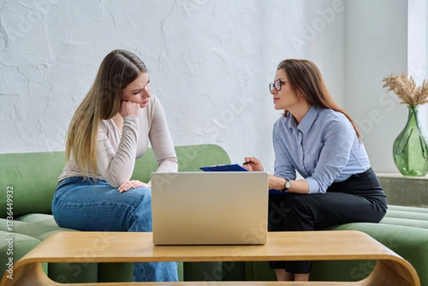 Fototapeta Young female patient during psychotherapy session with psychologist