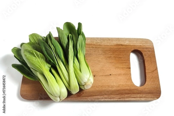 Fototapeta Fresh bok choy or pak choi or pakcoy (Brassica rapa subsp. chinensis) vegetables on the wooden cutting board. Isolated on white background with copy space.