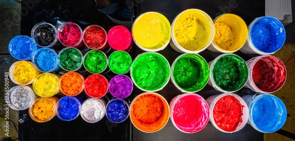 Fototapeta Colorful Ink for Screen Printing Factories
Inside a busy Tee shirt factory plastisol inks in multiple tones bright and dark are neatly arranged for industrial use. Workers use handmade tools handles