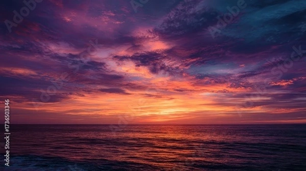 Fototapeta Vibrant Sunset Over Calm Ocean Waves with Colorful Sky and Clouds