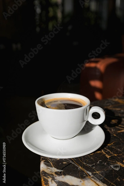 Fototapeta A cup of black coffee in a cafe with copy space