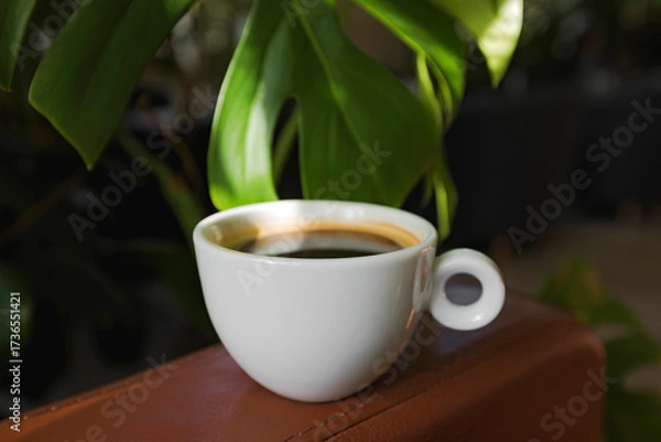 Fototapeta A cup of black coffee in a cafe with copy space