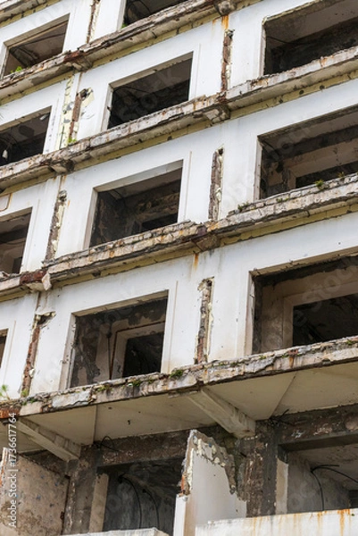 Fototapeta Facade of the abandoned high rise building construction site. Concept