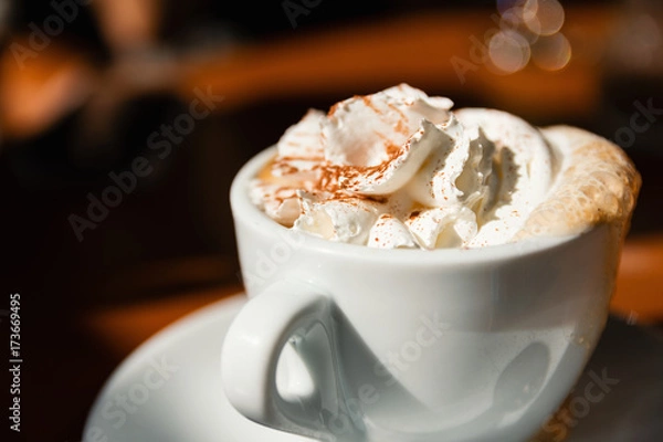 Fototapeta Close-Up Of Delicious Cappuccino With Fresh Whipped Cream And Cinnamon On Top