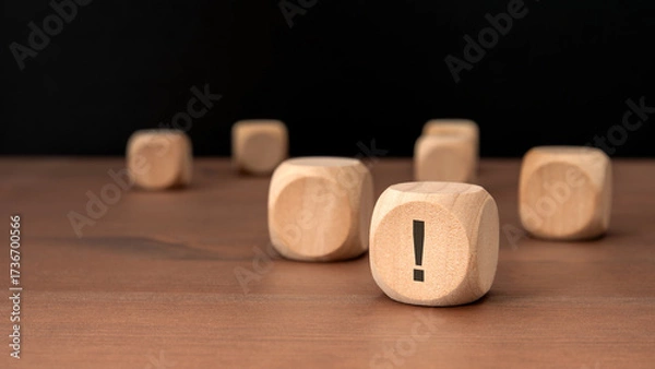 Fototapeta wooden cubes with exclamation marks on wooden table