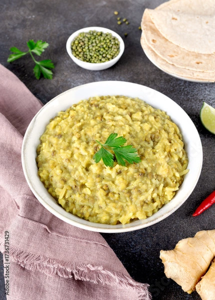 Fototapeta Indian Khichari with rice,lentils served with roti on gray background. Top view. Ayurveda diet
