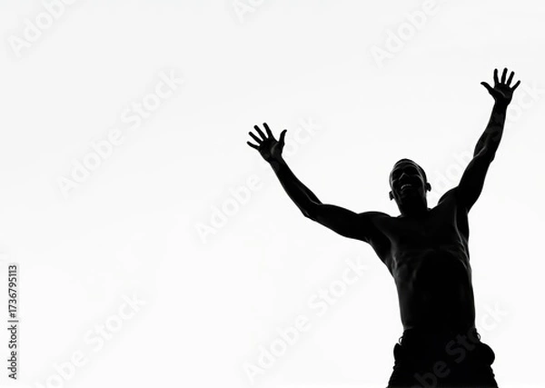 Fototapeta Triumphant male silhouette with raised arms celebrating success on white background copy space. Inspiring victory pose conveys achievement, freedom and joy. Motivational and wellness content.
