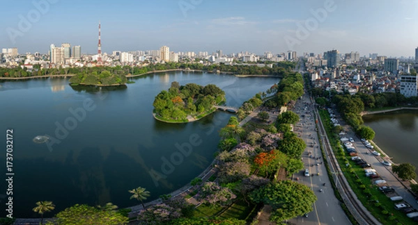 Fototapeta Wide panoramic view of Hanoi with Bay Mau lake, bridges, and urban skyline.
