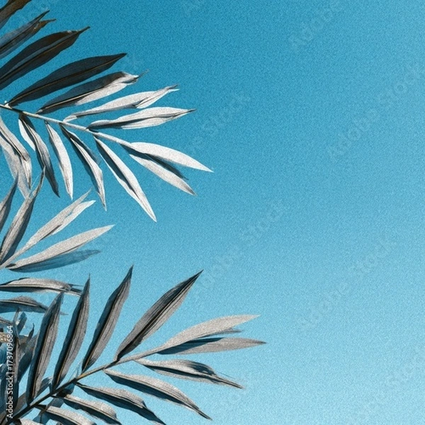 Obraz Silvery-toned plant leaves against a vibrant, textured blue backdrop, creating a serene effect