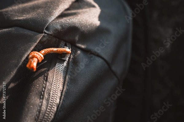 Fototapeta Close-Up Of Olive Green Backpack With Orange Zipper Placed On A Rock
