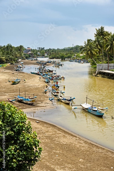 Fototapeta Coastal scene and local boats on the island of Java