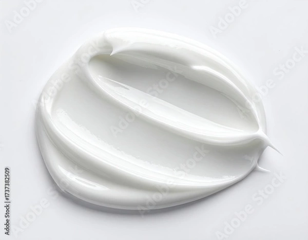 Fototapeta A close-up shot of a swirl of smooth, white cream on a bright white background