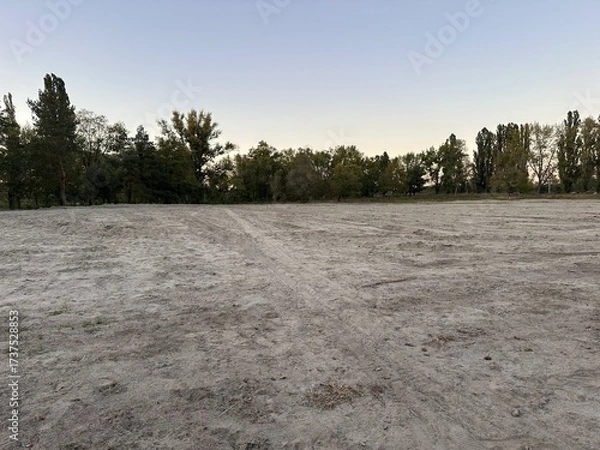 Fototapeta Leveled empty building site in open area in park