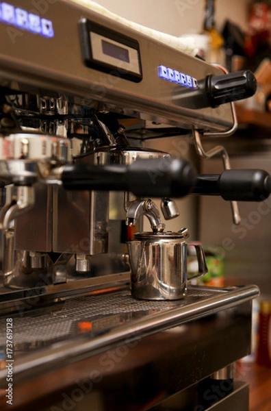 Obraz Close-up of a professional espresso machine with a small milk frothing pitcher.
