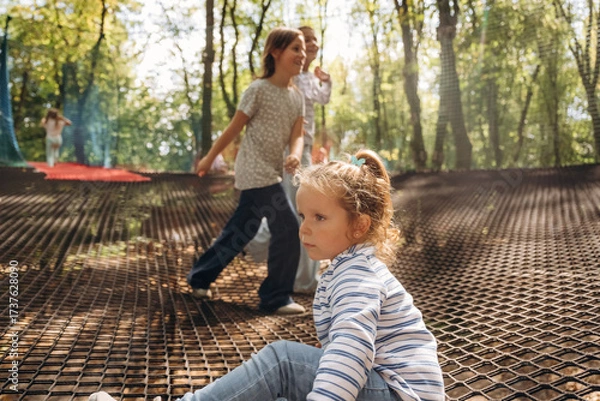 Obraz Kids are playing on the children's amusement ropes course