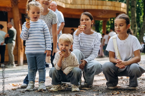 Obraz Eating ice cream. Group of kids are having fun together in the park
