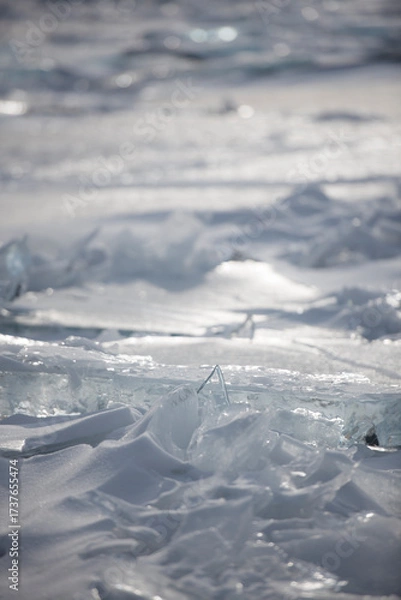 Fototapeta Sunlit broken ice and snow texture close-up