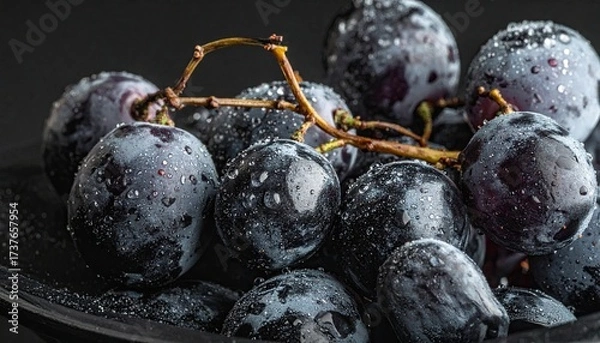 Fototapeta Close up of a bunch of grapes on a black background