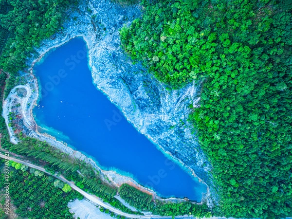 Fototapeta Aerial top view large pond There is blue water and the pine forest has a beautiful view like Switzerland.
beautiful The reflection of the blue sky in the emerald green pond.Stone Quarry in Phang Nga