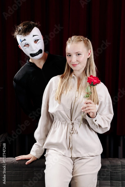 Fototapeta A loving mime expresses his feelings to a beautiful woman on a theater stage. Close-up.