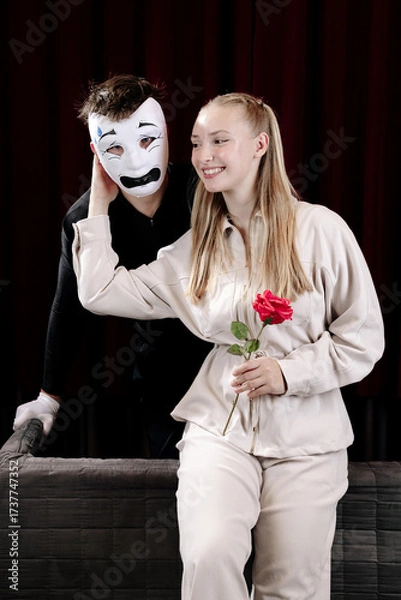 Fototapeta A loving mime expresses his feelings to a beautiful woman on a theater stage. Close-up.