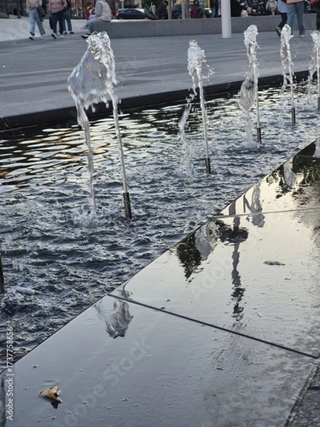 Fototapeta Working fountains in the park in the city center.