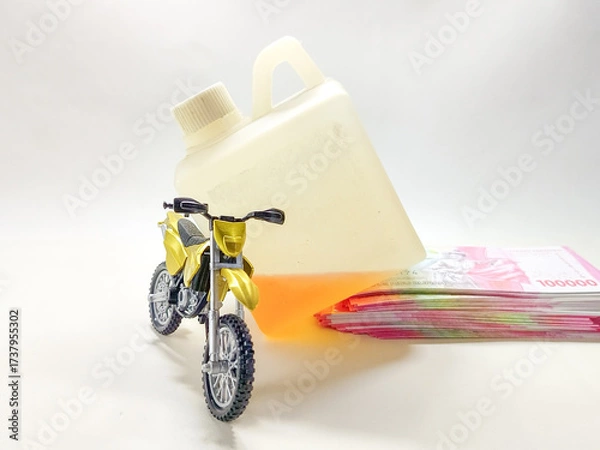Obraz A conceptual image illustrating the expensive cost of gasoline, featuring a toy motorcycle, spilled fuel, and a stack of money