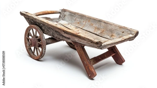 Fototapeta Rustic wooden wheelbarrow, weathered and aged, isolated on white.