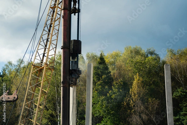 Fototapeta Pile driver install piles on the construction site at daytime