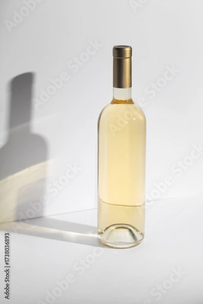 Fototapeta White Wine bottle mockup with golden cap, showcasing elegant design and smooth glass texture, ideal for branding and marketing concepts with copy space