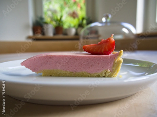 Fototapeta Clean slice of a home baked strawberry cake in an elegant setting. 