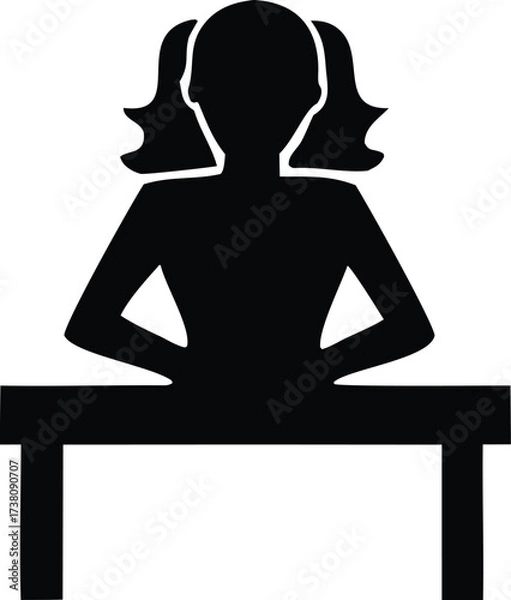 Fototapeta Silhouette of a young girl with pigtails sitting at a desk focused on her studies or work