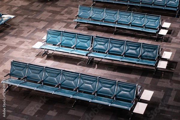 Fototapeta Modern Airport Waiting Area with Rows of Blue Seats, Spacious Terminal Lounge Featuring Contemporary Chair Arrangements