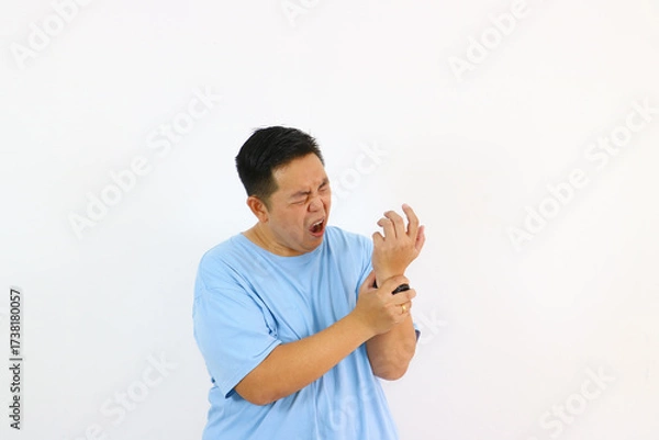 Fototapeta Man in pain holding wrist and screaming isolated on white background