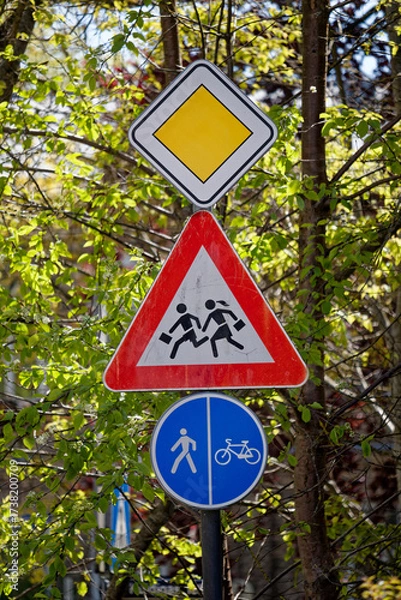 Fototapeta European Priority Road Sign with Children Warning and Shared Pedestrian Bicycle Path Sign