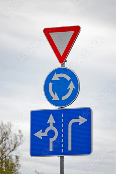 Fototapeta European Road Signs Showing Yield, Roundabout Ahead and Lane Usage Directions