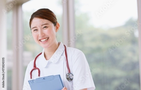 Fototapeta Smiling Senior Doctor Using Laptop in Office
