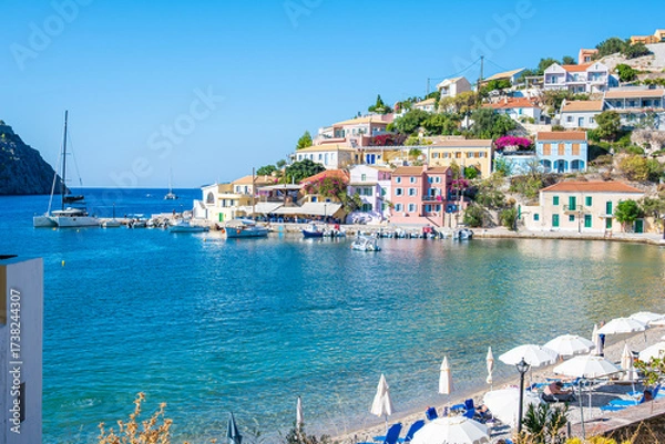 Fototapeta Sunny Day at Assos Village: Wide View of the Harbor, Colorful Waterfront Buildings, and Beach Activities, Kefalonia